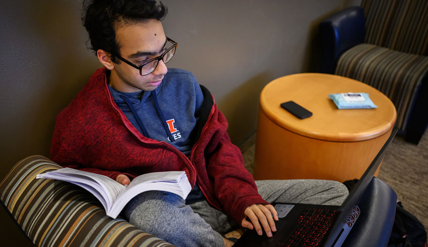 business student studying in the common area of their dorm