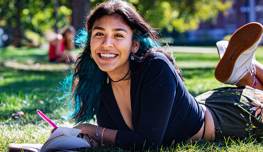 student studying in the sun on the Quad