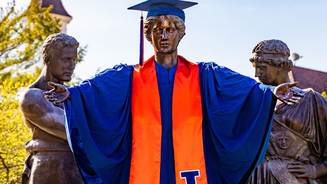 Alma Mater wearing full graduation regalia