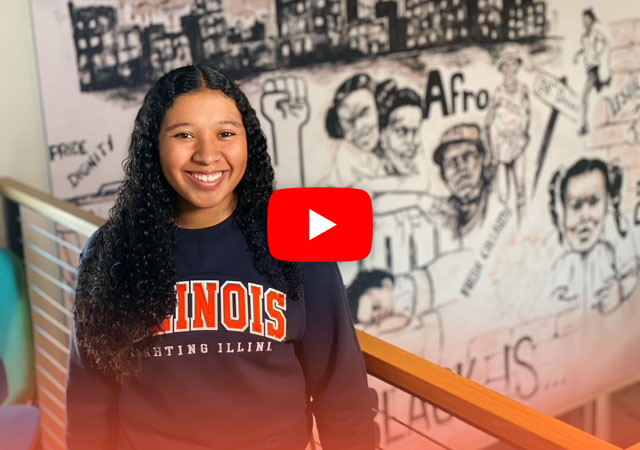 Kennedy in front of a mural in the newly renovated Bruce D. Nesbitt African American Cultural Center