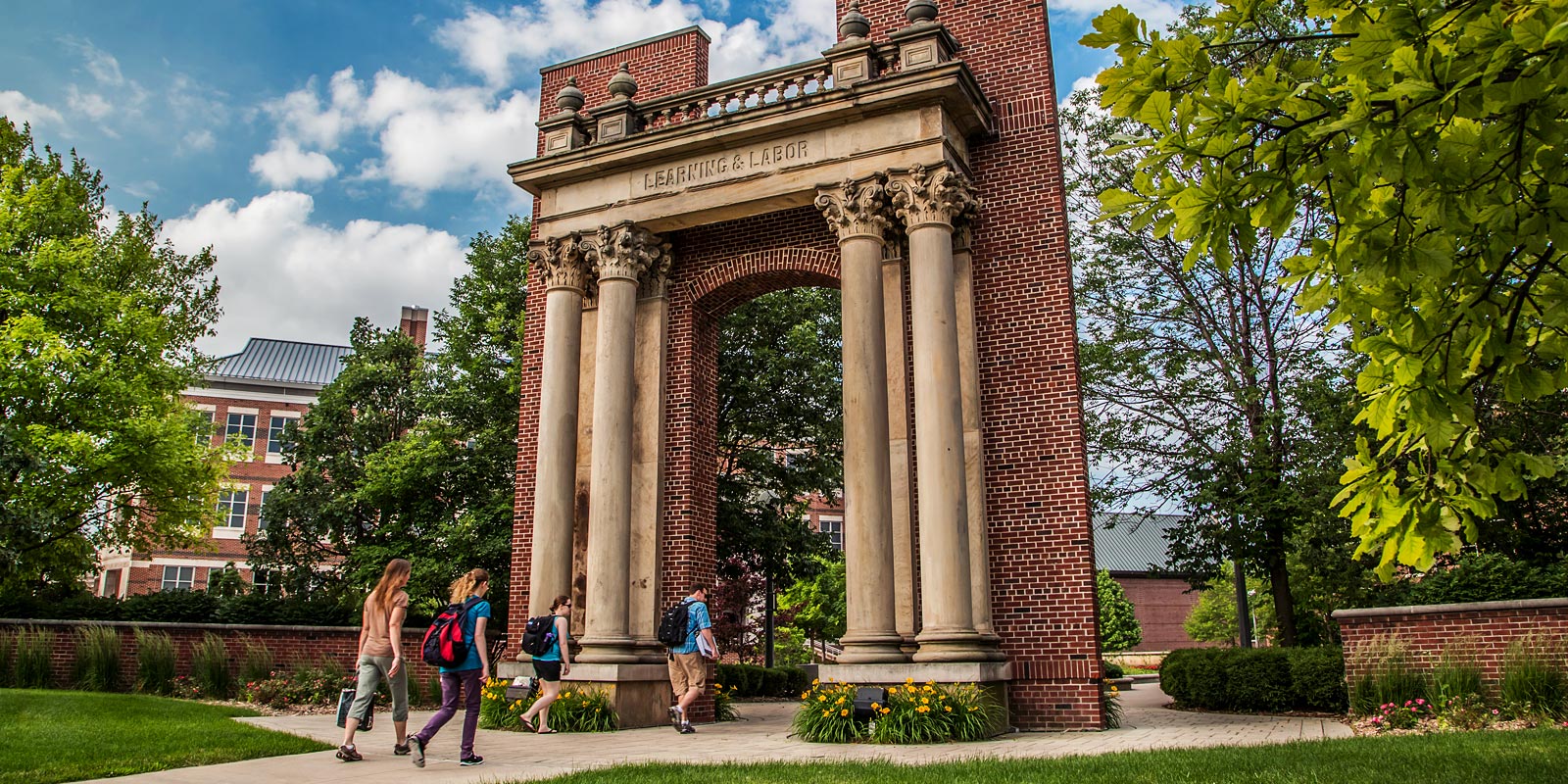 students passing through Hallene Gateway on their way to class