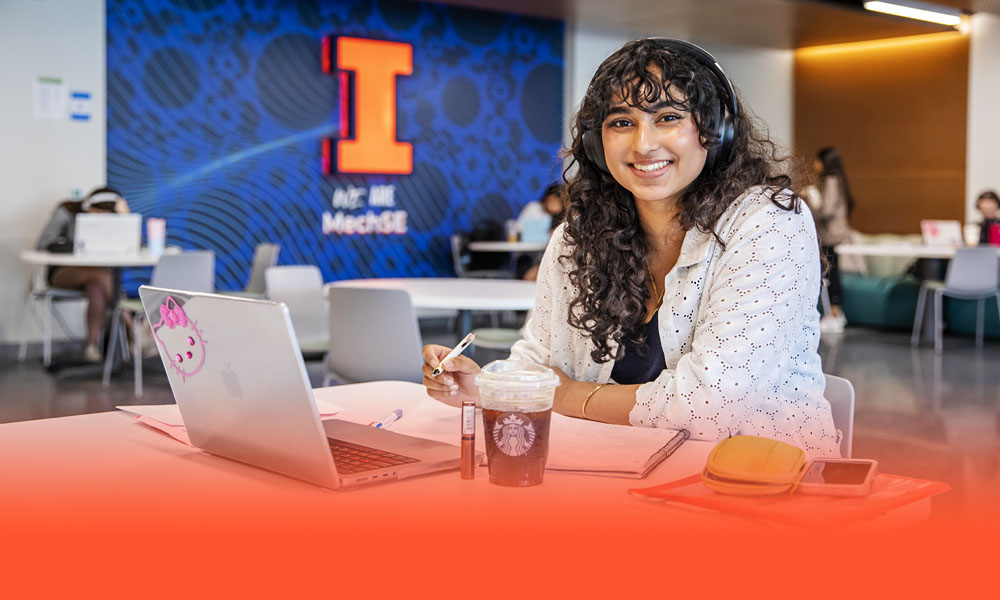 undergraduate Mechanical Science and Engineering student wearing headphones and studying in one of many common areas on the Engineering campus