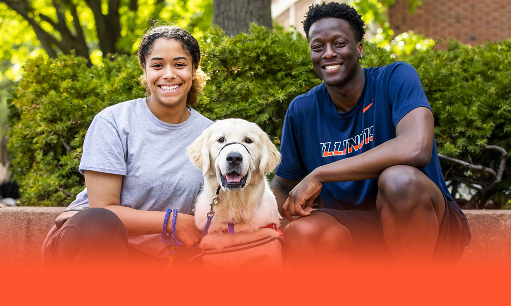 students pose with dog outside the Illini Union
