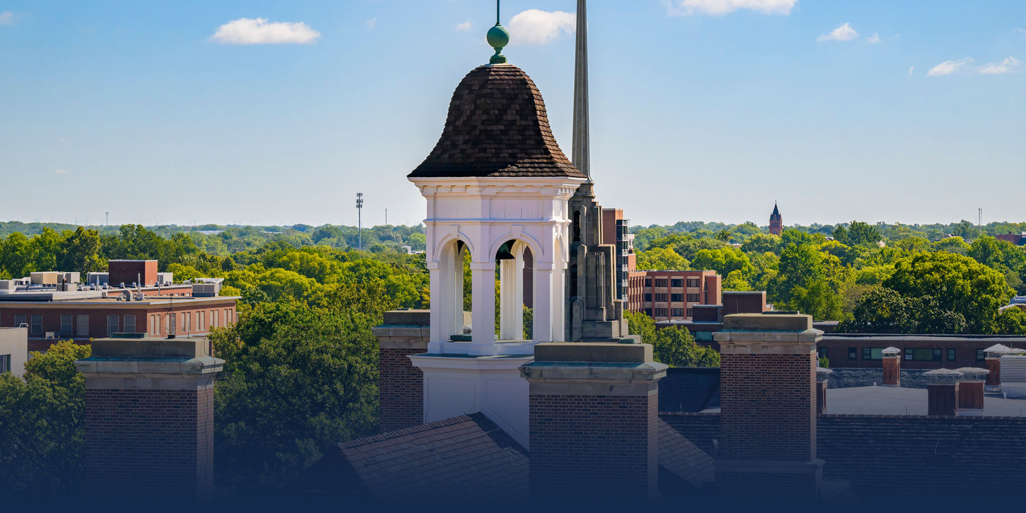 the Illini Union overlooking the east portion of campus and its landmarks from amongst the treetops