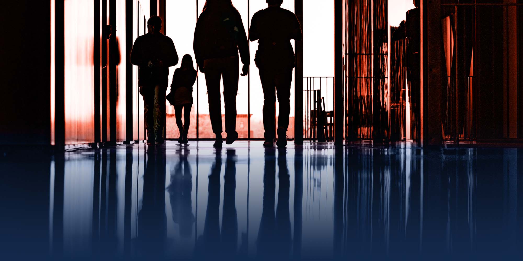 artistic shot of students and their reflections in a Campus Instructional Facility hallway