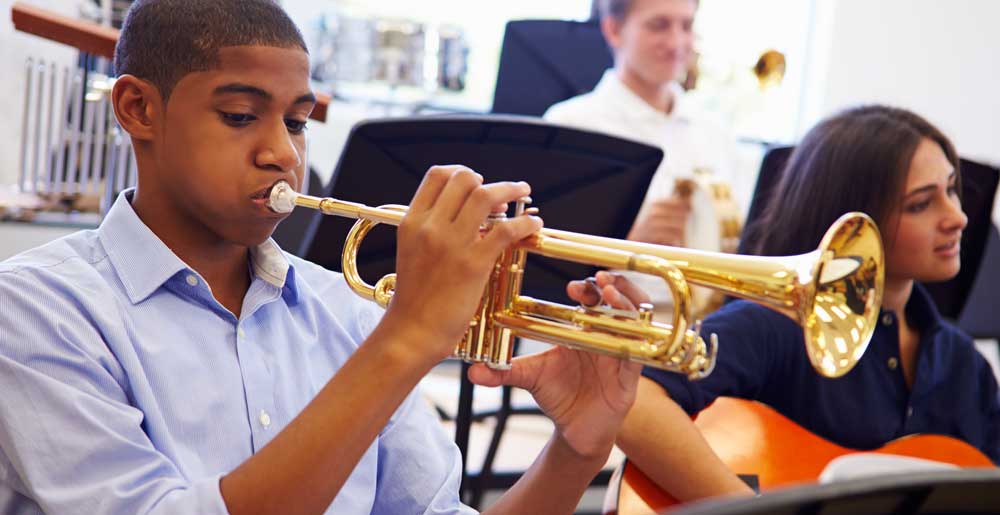 high school student playing the trumpet in band