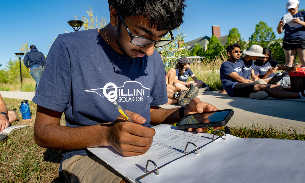 members of the Illini Solar Car team from the University of Illinois Urbana-Champaign prepares for competition in the 2022 American Solar Challenge