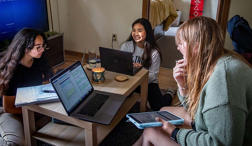 roommates studying with each other in their dorm room