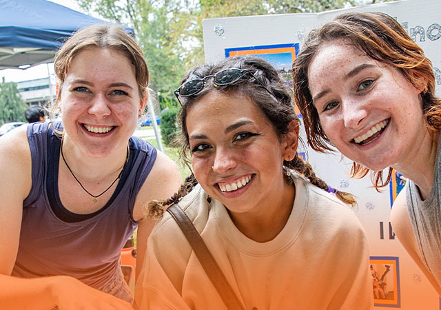 three friends representing an RSO together on Quad Day