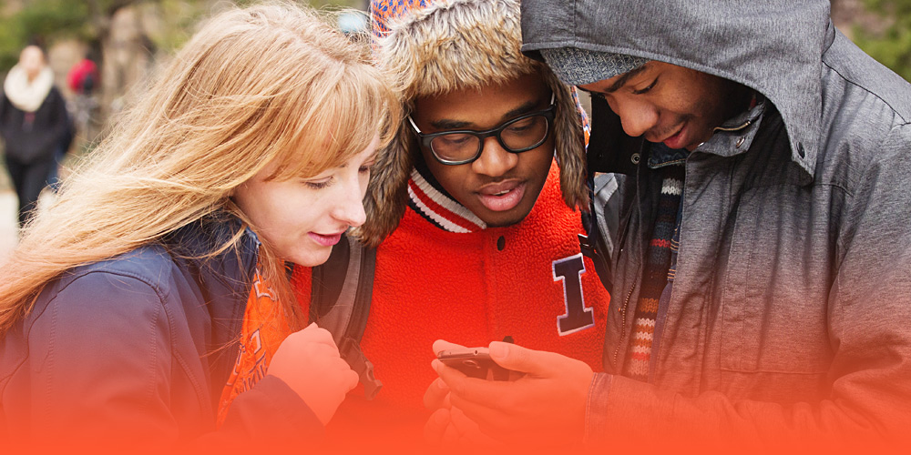 students checking the Illini-Alert on their phones