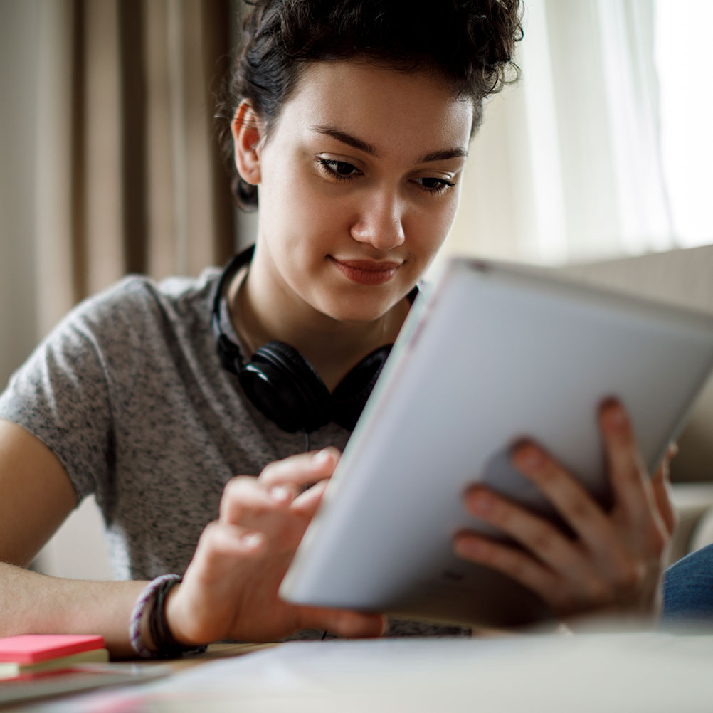 student watching an info session on an iPad