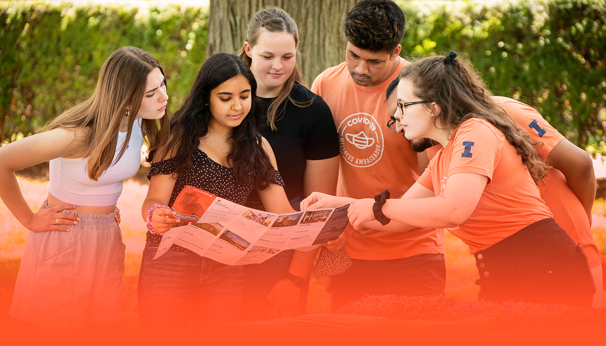 Wellness Ambassadors directing new students with a campus map