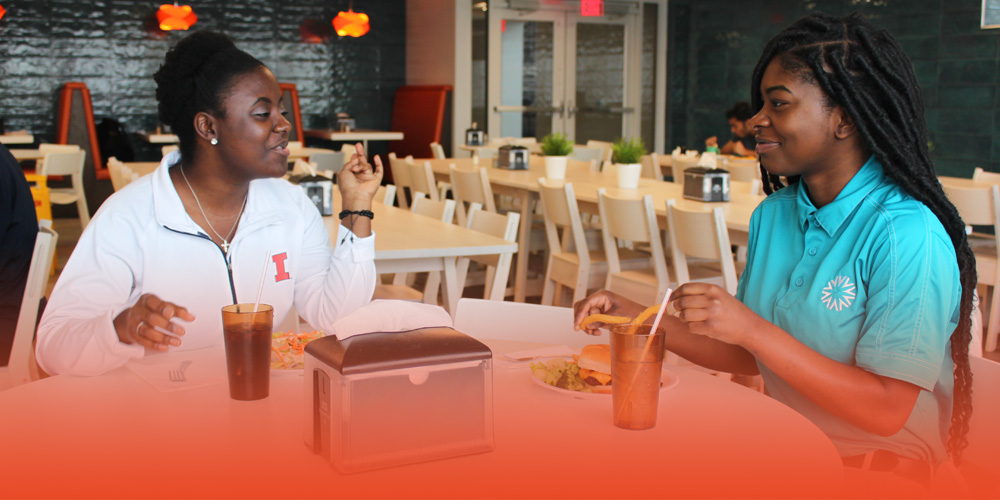 two student eating together in a PCH dining hall